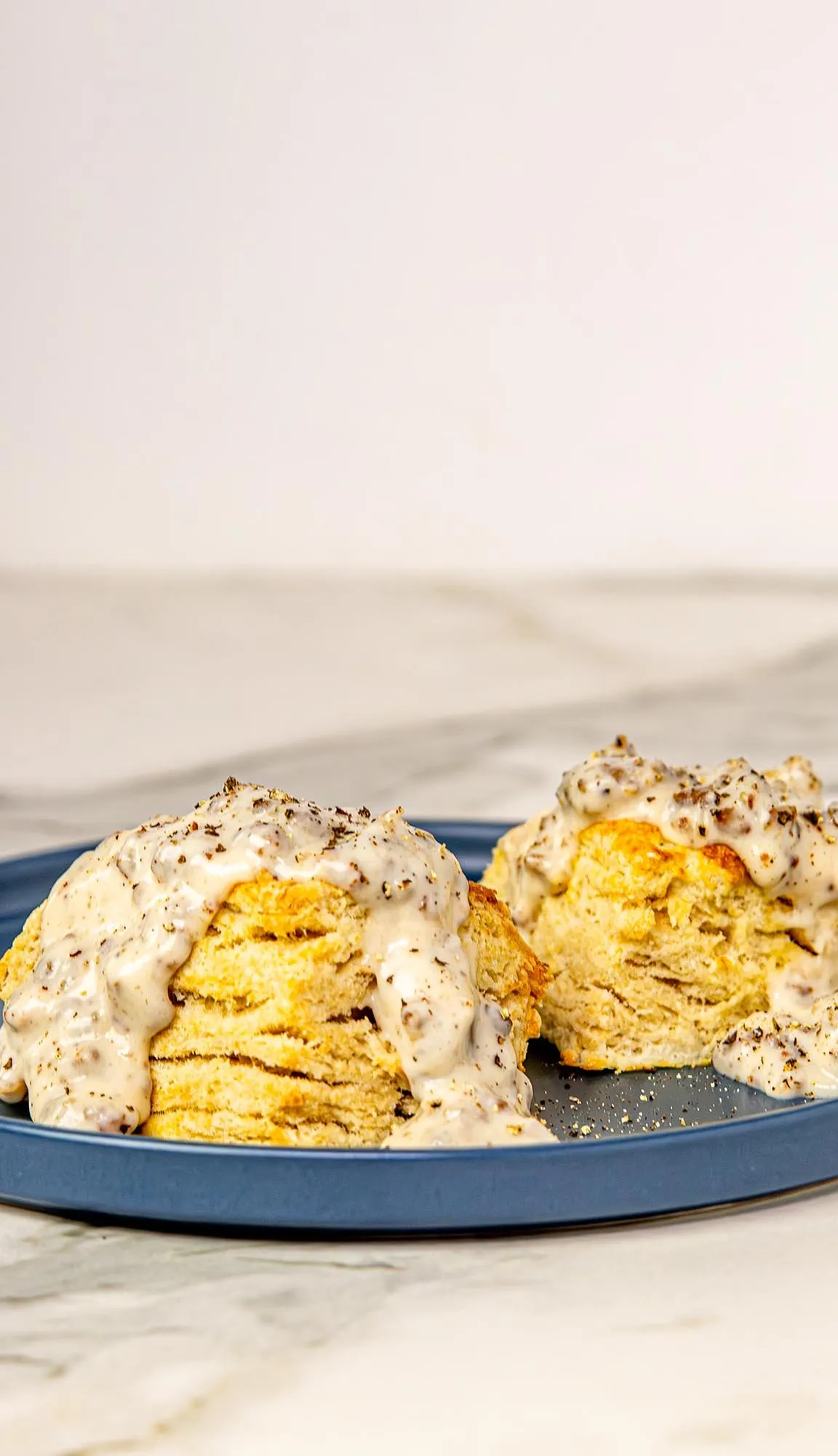 Air Fryer Biscuits and gravy on a blue plate