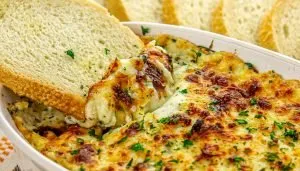 Air Fryer Baked Ricotta Dip with sliced bread being dipped in