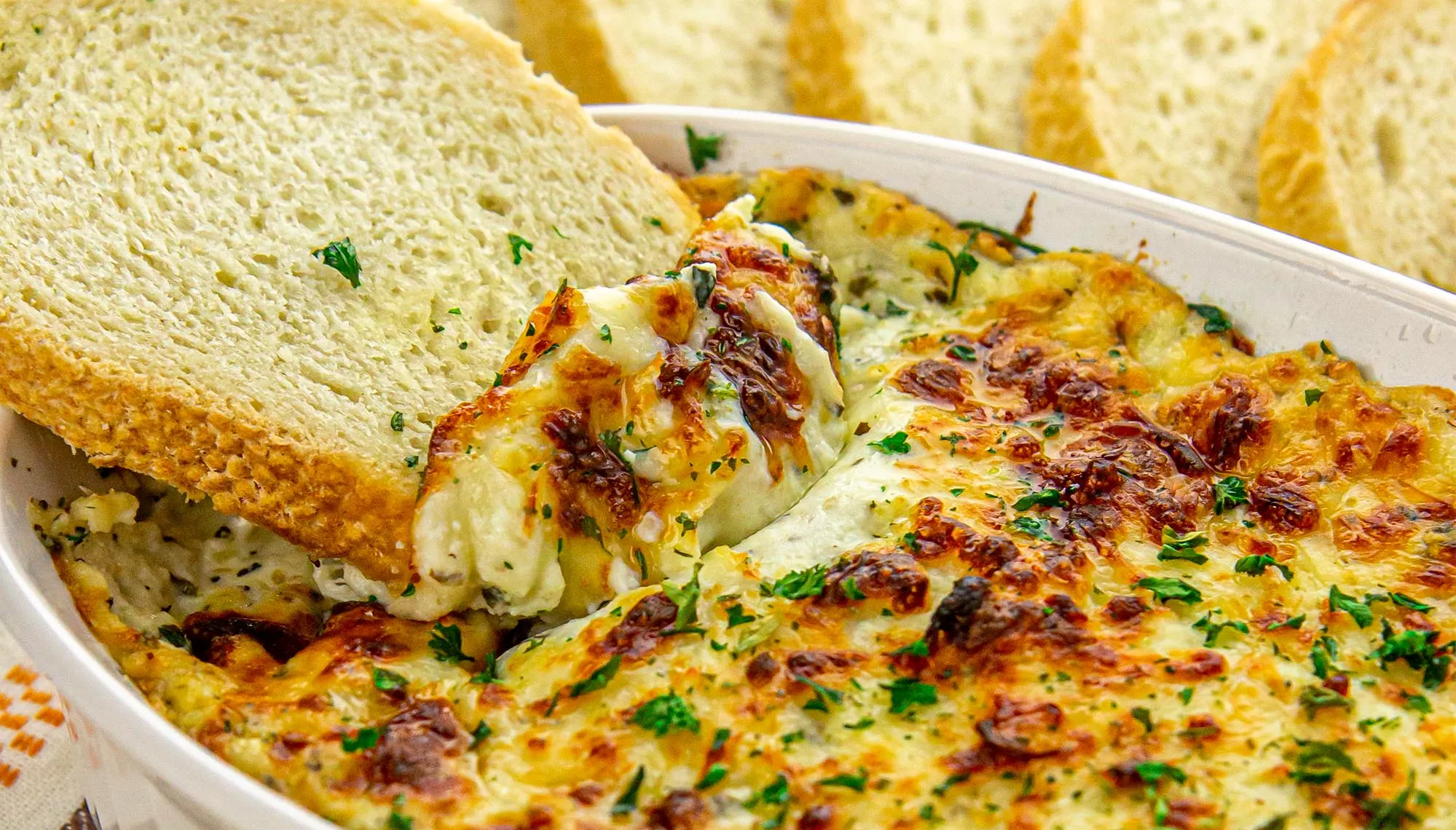 Air Fryer Baked Ricotta Dip with sliced bread being dipped in