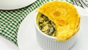 cut into pot pie with spinach and artichoke filling showing