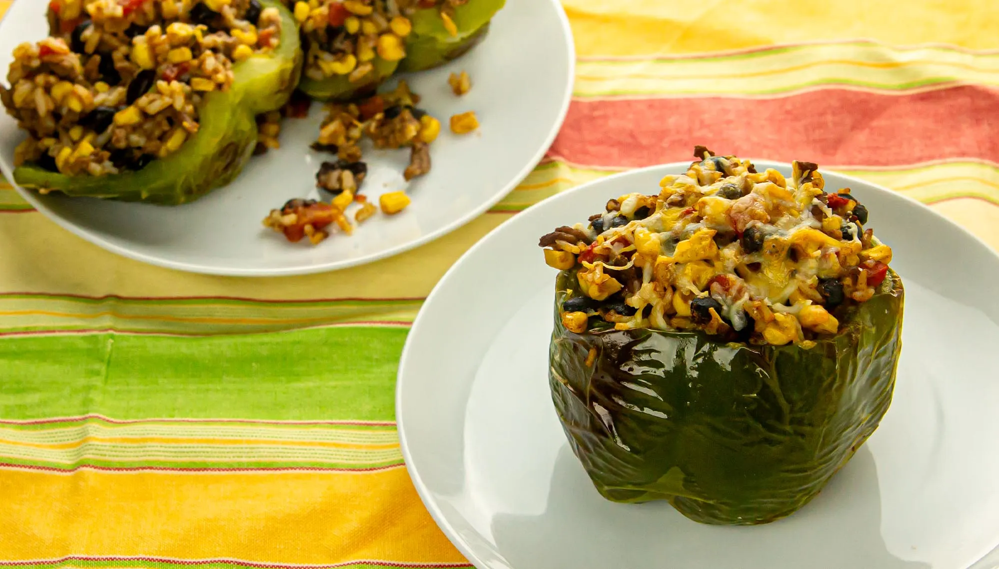 green peppers stuffed with black beans, corn, ground beef, and rice; topped with cheese