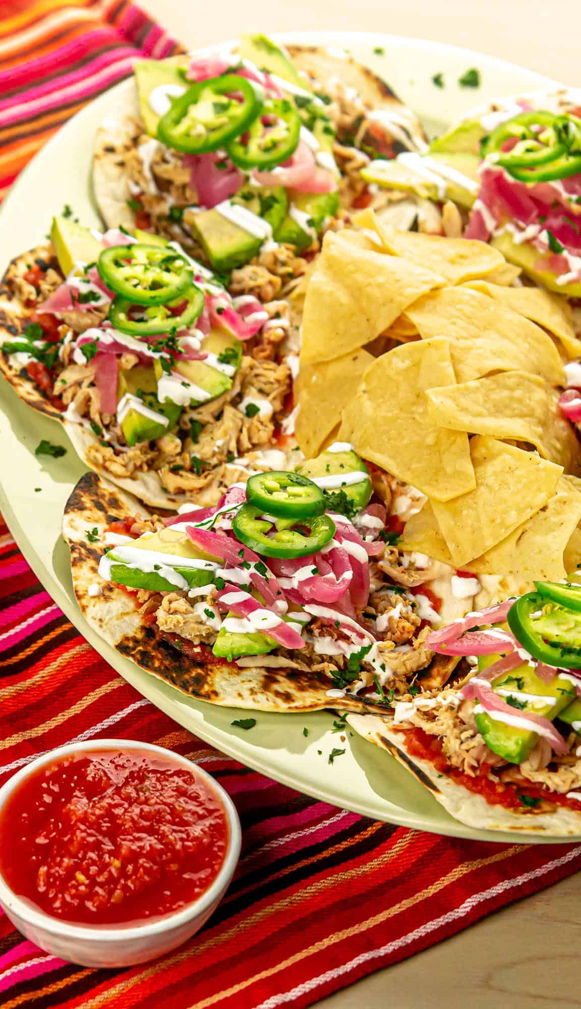 Chicken tacos with pickled onions, sour cream, avocados, and jalapeños