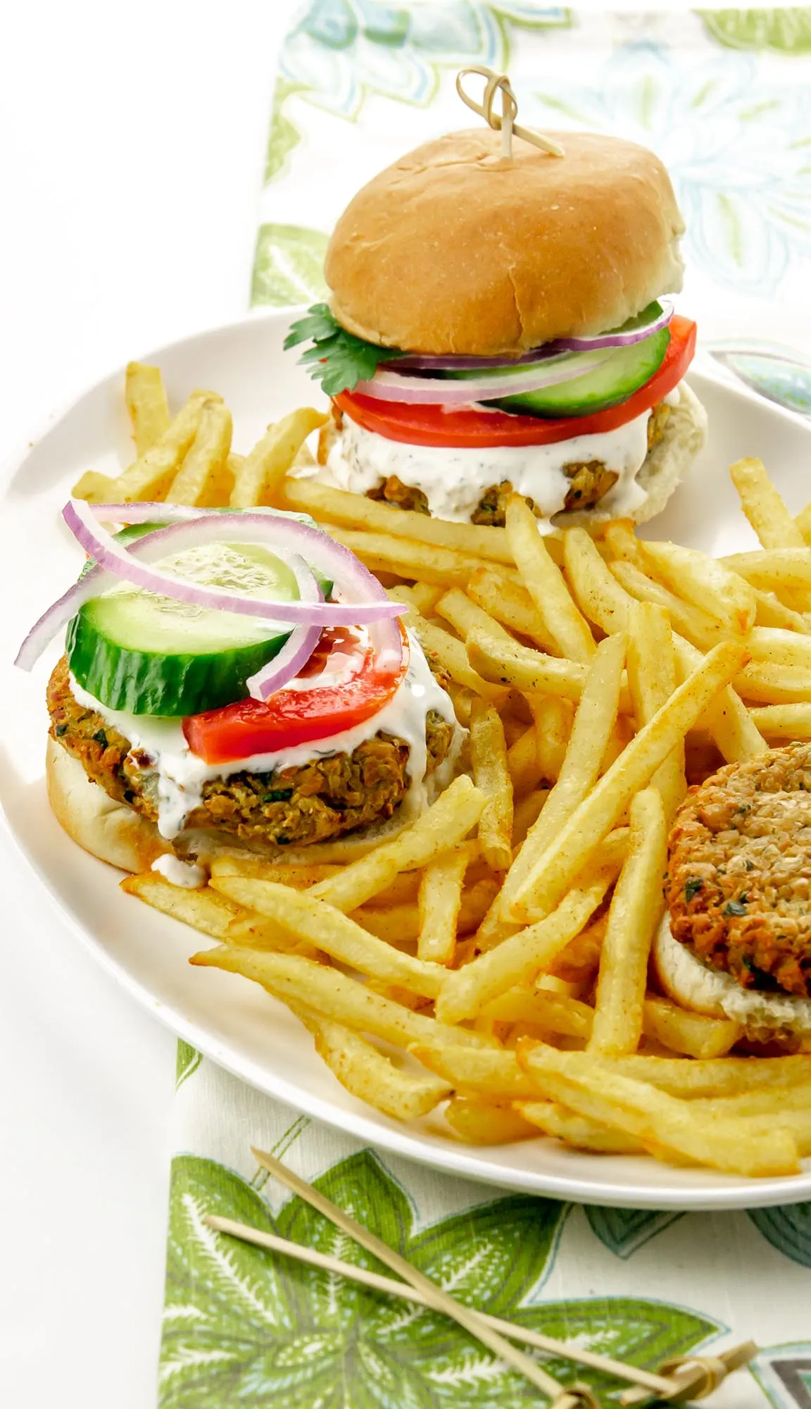 3 sliders with falafel patties on a platter with fries