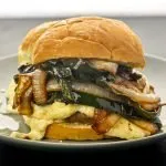 Pepper jack topped pork burger smothered in caramelized onions and poblano peppers