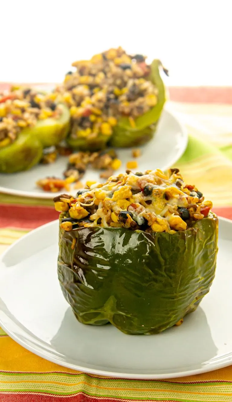 green peppers stuffed with black beans, corn, ground beef, and rice; topped with cheese