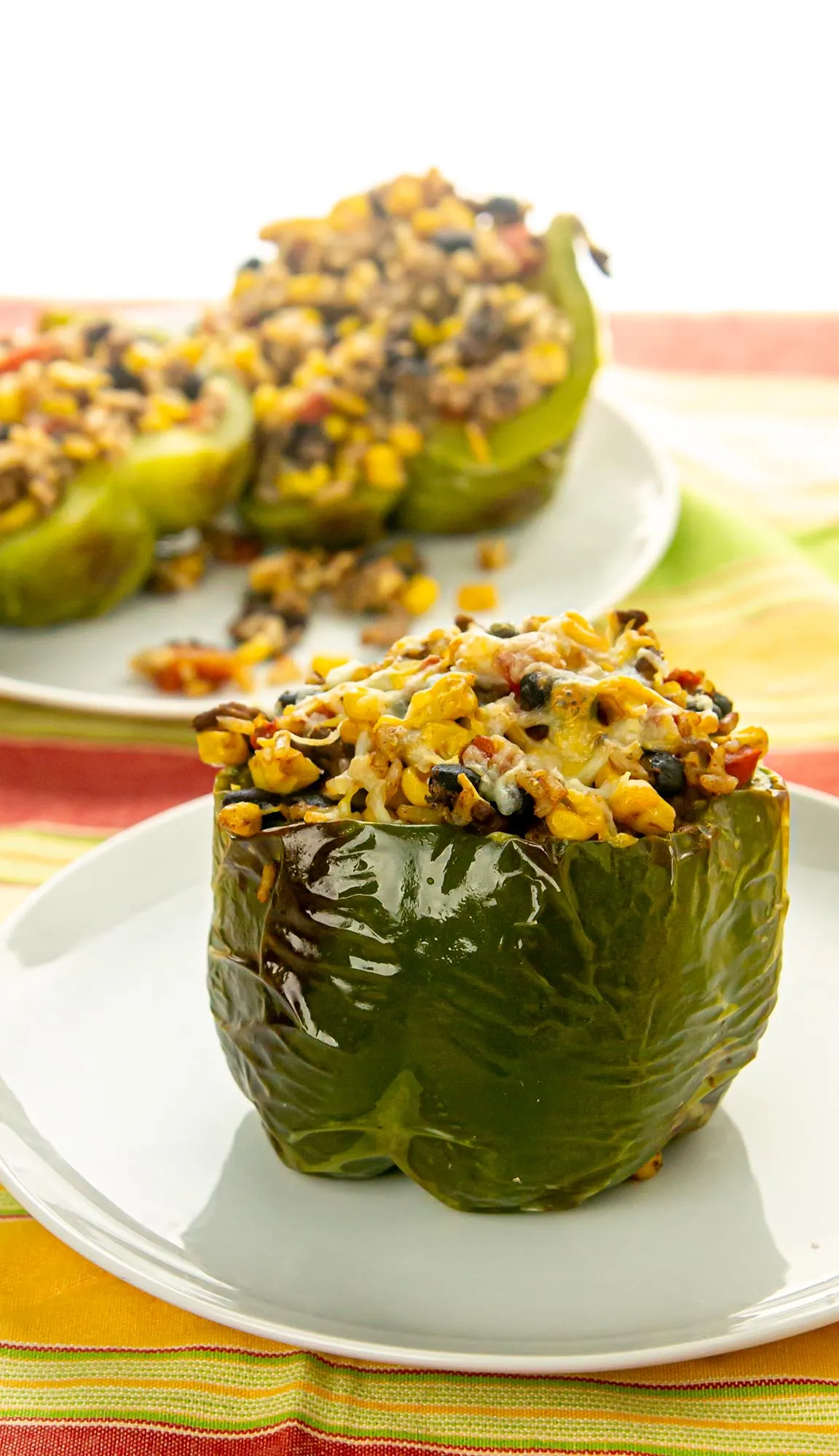 green peppers stuffed with black beans, corn, ground beef, and rice; topped with cheese