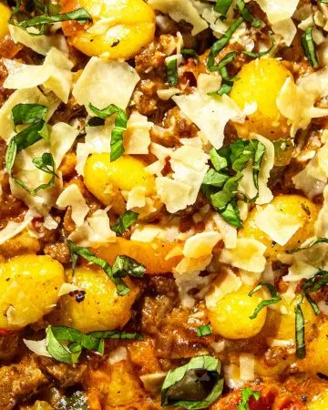 Gnocchi baked with ground meat, tomato sauce, topped with shaved cheese and chopped fresh basil.